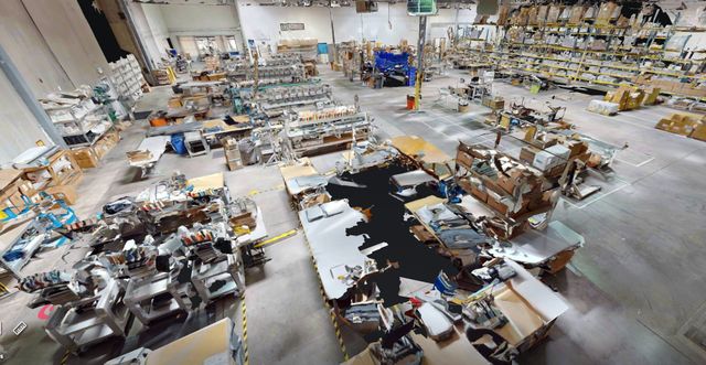 3D tour view of the embroidery, digital and fulfillment floor, with rows of machines and packing stations