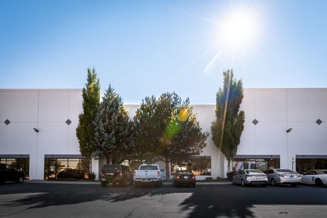 Front of the Silverscreen building in Reno on a sunny day, with trees and parked cars