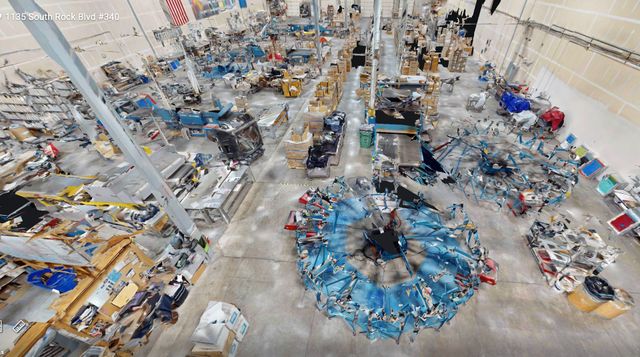 3D tour view of the screen printing floor, with blue carousel presses seen from above