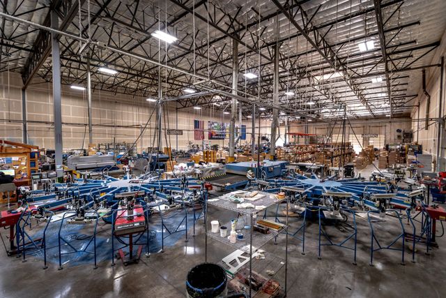Wide view of the Silverscreen production floor with rows of automatic screen printing presses